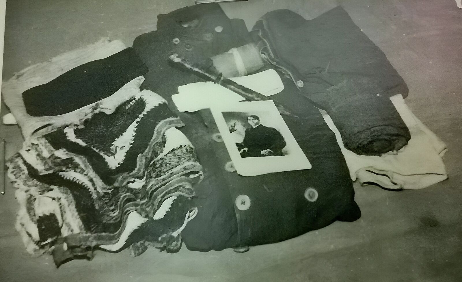 Preserved garments laid flat in a museum display case, photographed from above.
